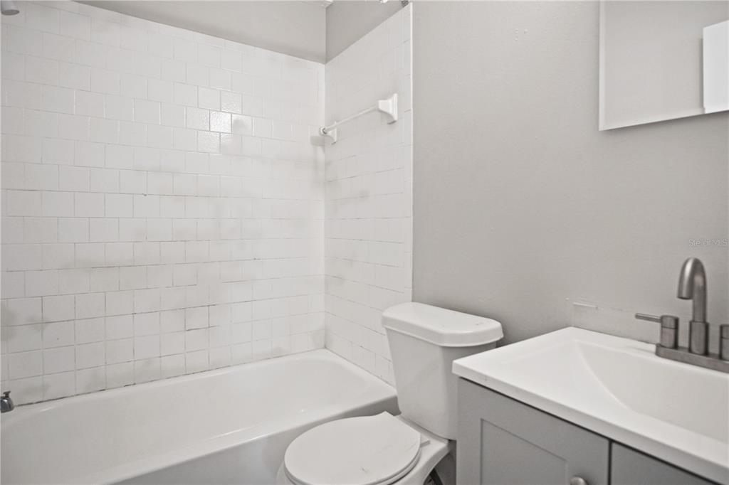 1480 32nd Street Northwest Winter Haven, FL 33881 - Photo 11 of 13 a bathroom with a toilet a sink and bathtub