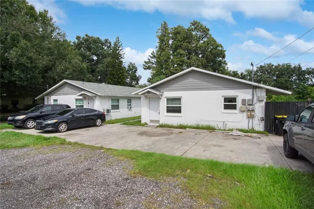 a front view of house with yard and green space