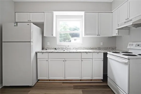 a white refrigerator freezer sitting inside of a kitchen