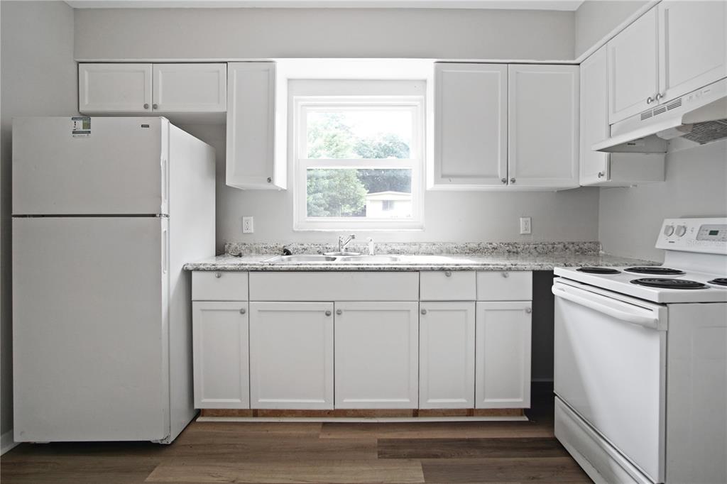 1480 32nd Street Northwest Winter Haven, FL 33881 - Photo 4 of 13 a white refrigerator freezer sitting inside of a kitchen