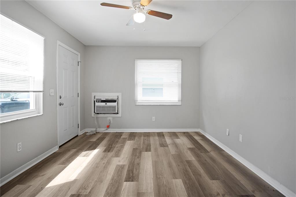 1480 32nd Street Northwest Winter Haven, FL 33881 - Photo 8 of 13 wooden floor in an empty room with a window
