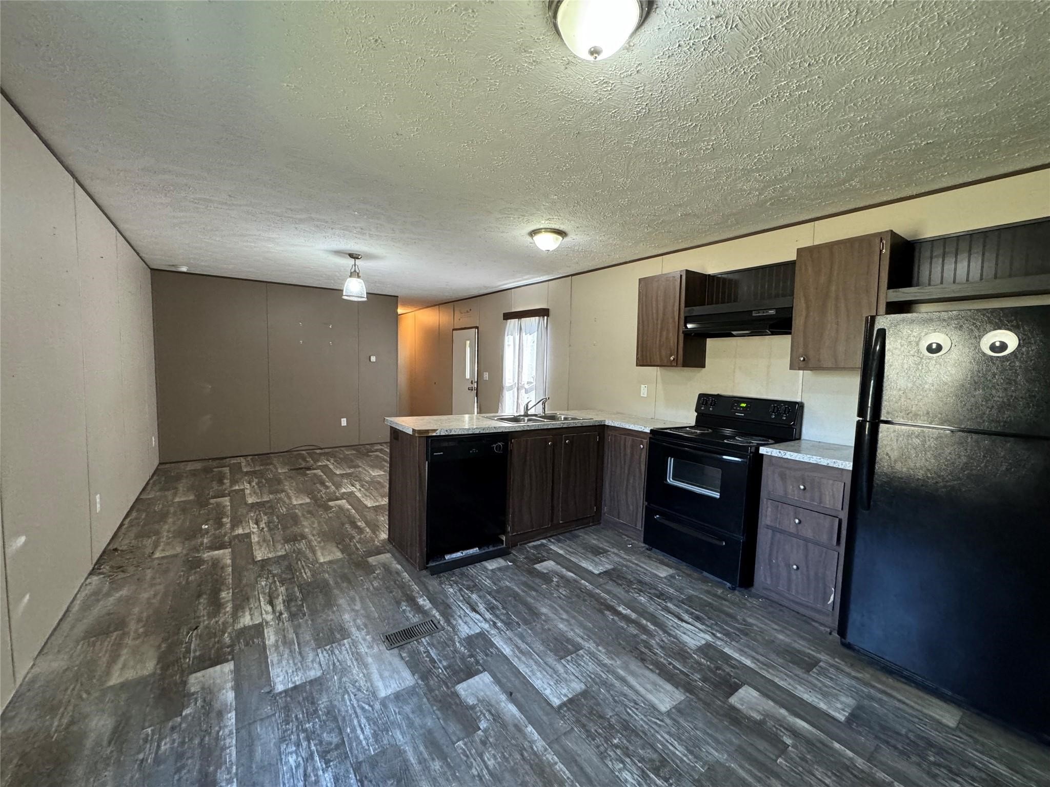 18093 Pickering Road Conroe, TX 77302 - Photo 10 of 29 a kitchen with a refrigerator and a sink