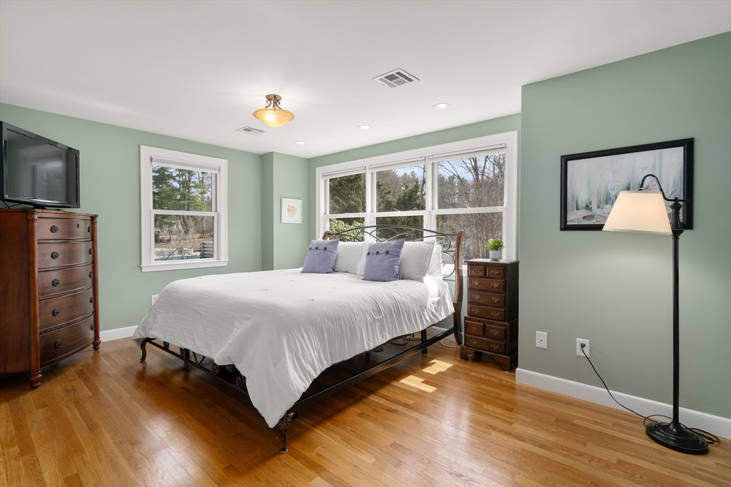 23 Alta Road Sudbury, MA 01776 - Photo 16 of 38 a spacious bedroom with a large bed and a flat tv screen on dresser