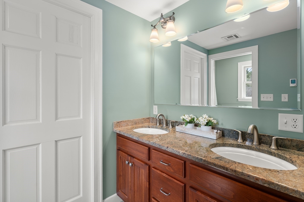 23 Alta Road Sudbury, MA 01776 - Photo 18 of 38 a bathroom with a granite countertop double vanity sink and a mirror