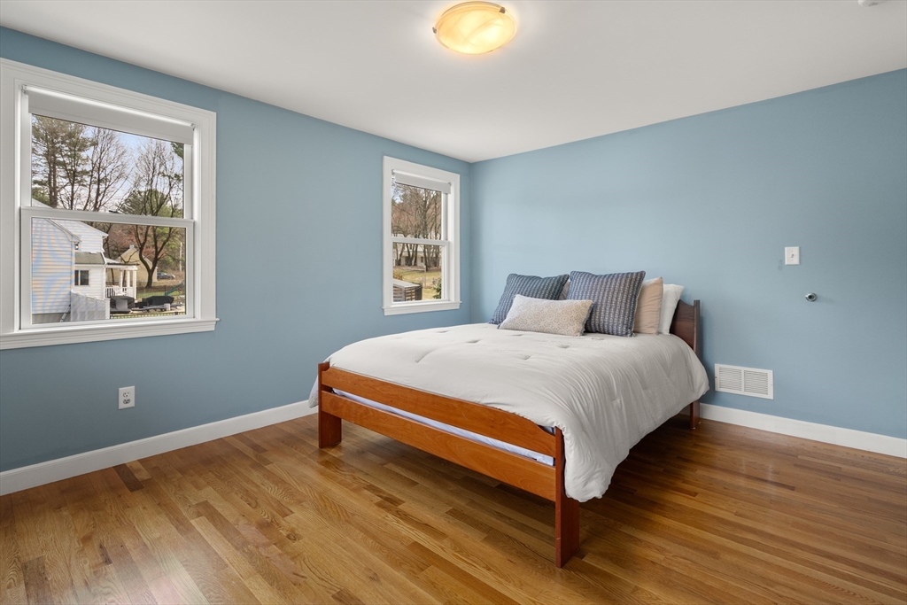 23 Alta Road Sudbury, MA 01776 - Photo 20 of 38 a bedroom with a bed lamp and window