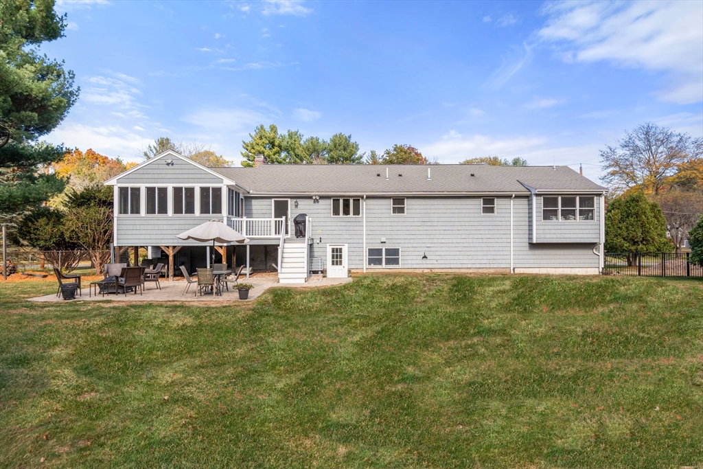 23 Alta Road Sudbury, MA 01776 - Photo 3 of 38 a front view of a house with a yard table and chairs