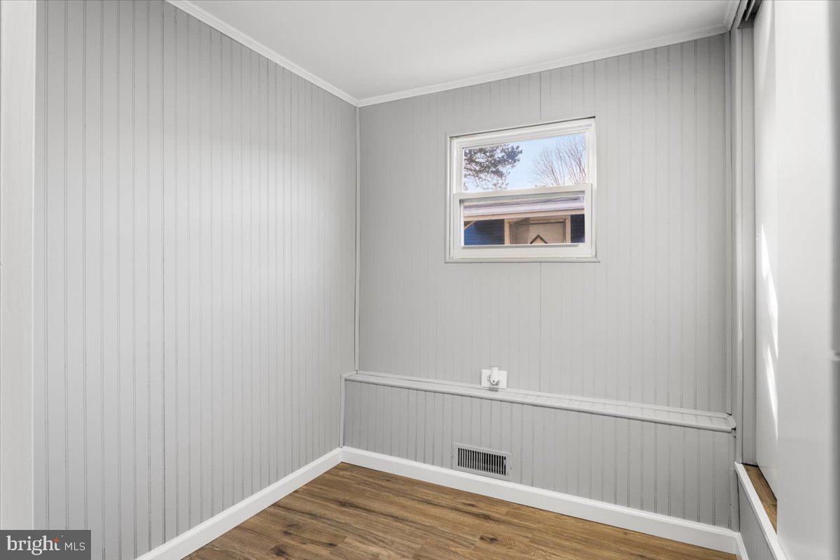 114 Cookstown New Egypt Road Wrightstown, NJ 08562 - Photo 14 of 30 a view of an empty room with wooden floor and a window