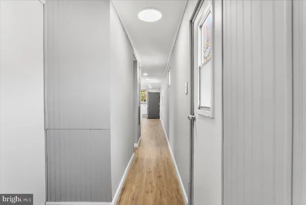 a view of a hallway with wooden floor and glass doors