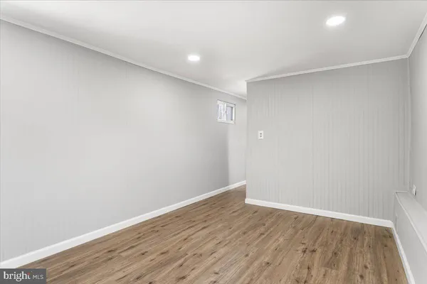 a view of an empty room with wooden floor