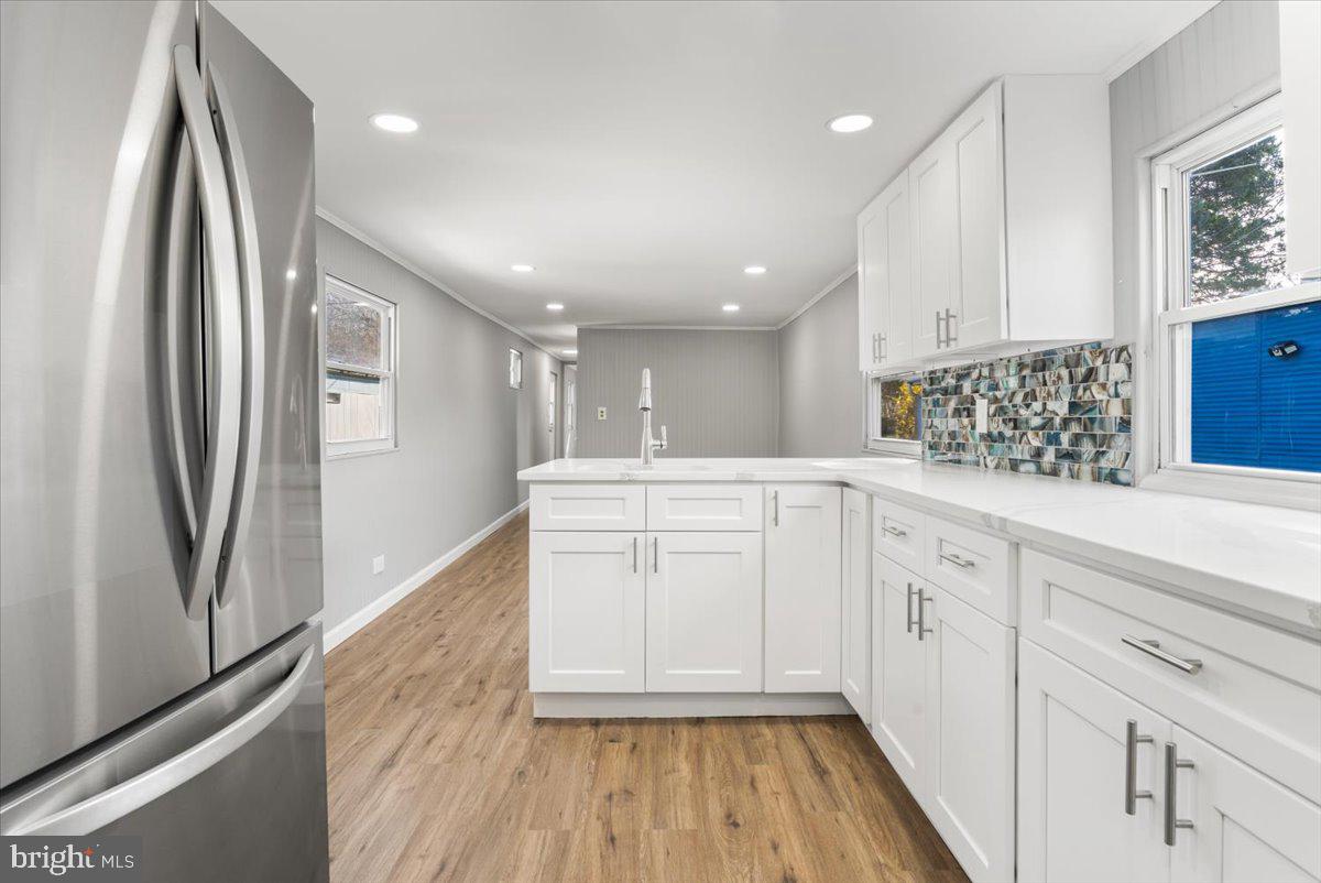114 Cookstown New Egypt Road Wrightstown, NJ 08562 - Photo 2 of 30 a kitchen with white cabinets and wooden floor