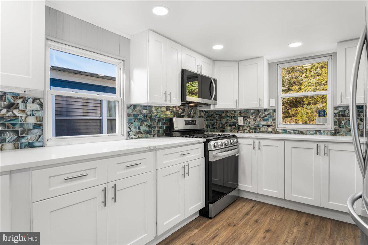 114 Cookstown New Egypt Road Wrightstown, NJ 08562 - Photo 22 of 30 a kitchen with white cabinets appliances a sink and a window