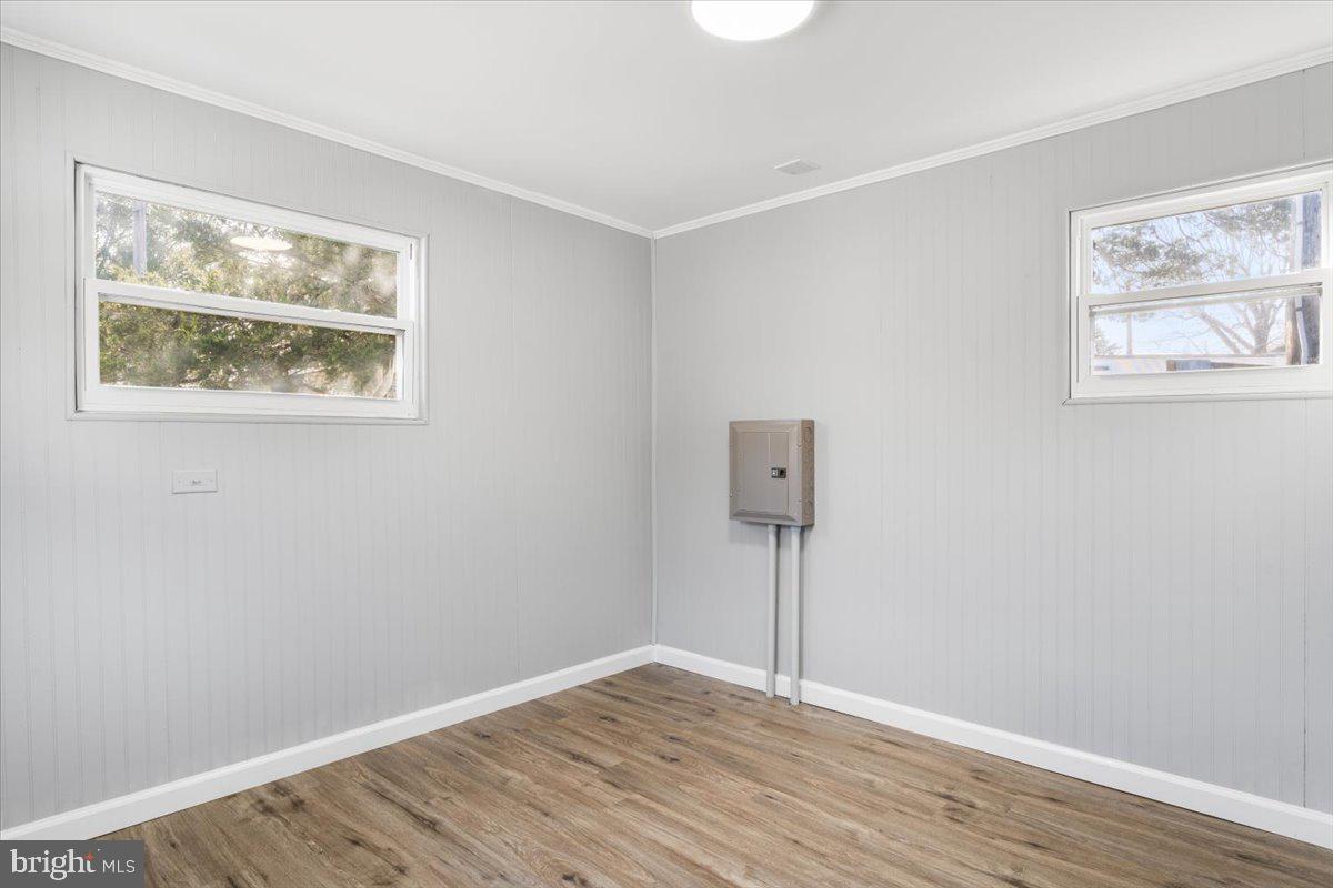 114 Cookstown New Egypt Road Wrightstown, NJ 08562 - Photo 9 of 30 a view of an empty room with wooden floor and a window