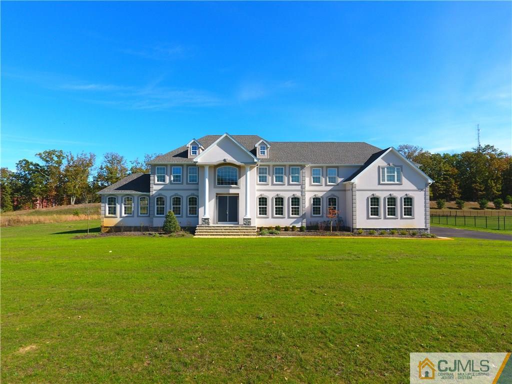 4 Beacon Hill Millstone Township, NJ 08510 - Photo 1 of 19 a front view of a house with a garden and yard