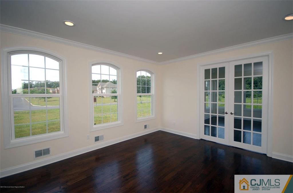 4 Beacon Hill Millstone Township, NJ 08510 - Photo 12 of 19 a view of an empty room with wooden floor and a window
