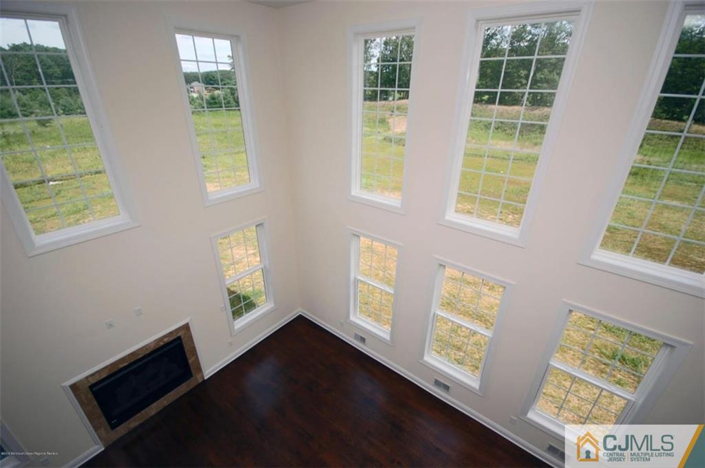 4 Beacon Hill Millstone Township, NJ 08510 - Photo 14 of 19 an empty room with wooden floor and windows