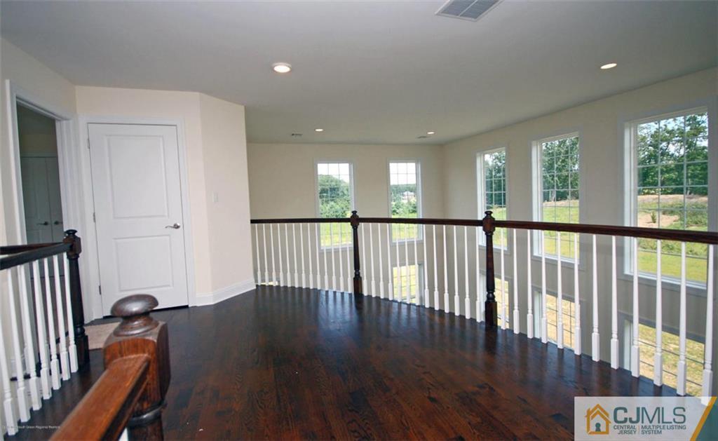 4 Beacon Hill Millstone Township, NJ 08510 - Photo 15 of 19 a view of a hallway with wooden floor