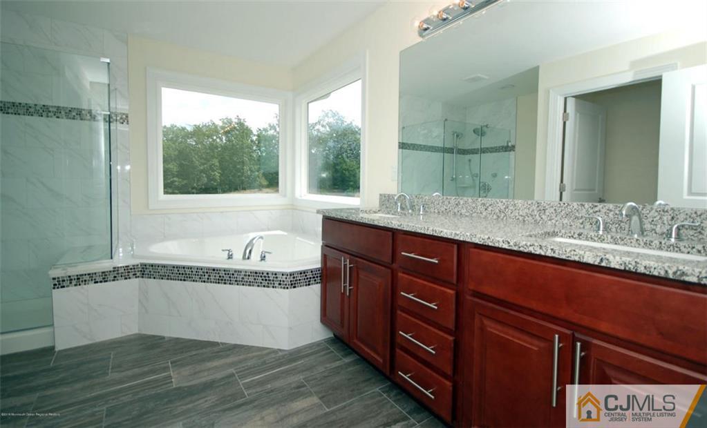 4 Beacon Hill Millstone Township, NJ 08510 - Photo 18 of 19 a bathroom with a granite countertop bathtub and a sink