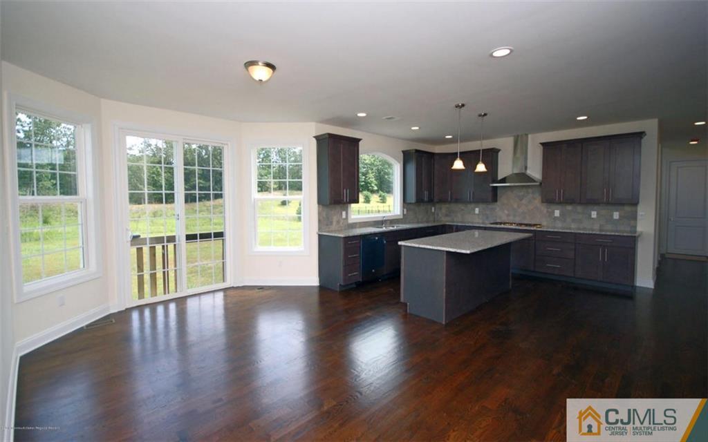 4 Beacon Hill Millstone Township, NJ 08510 - Photo 6 of 19 a large kitchen with stainless steel appliances granite countertop a large window a sink and a stove