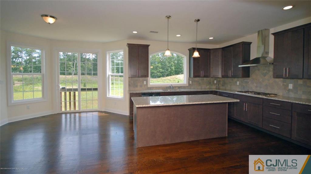 4 Beacon Hill Millstone Township, NJ 08510 - Photo 7 of 19 a large kitchen with stainless steel appliances granite countertop a stove a sink and a large window