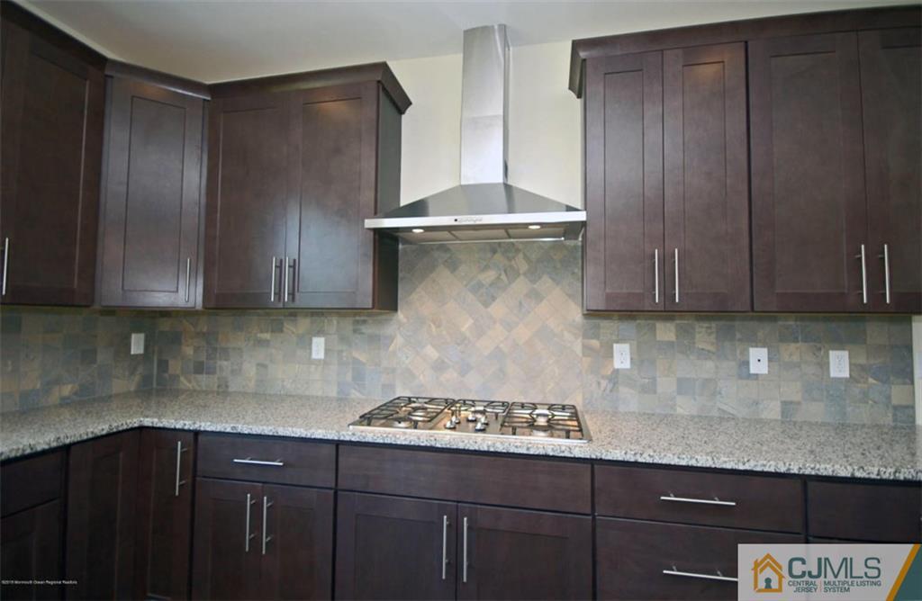 4 Beacon Hill Millstone Township, NJ 08510 - Photo 8 of 19 a kitchen with a sink a stove and cabinets