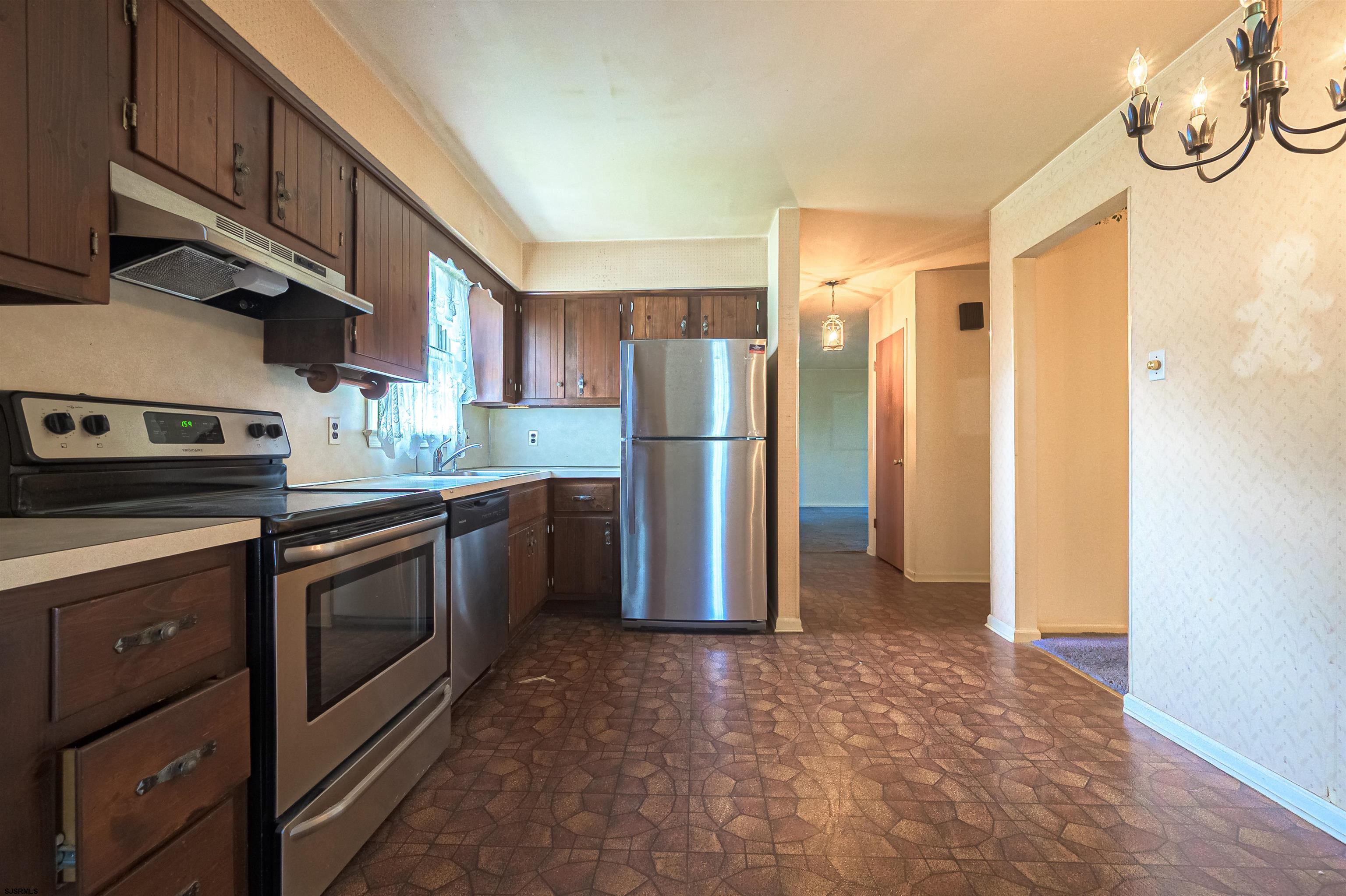 125 North Shore Road Marmora, NJ 08223 - Photo 12 of 29 a kitchen with stainless steel appliances granite countertop a refrigerator a stove and a sink