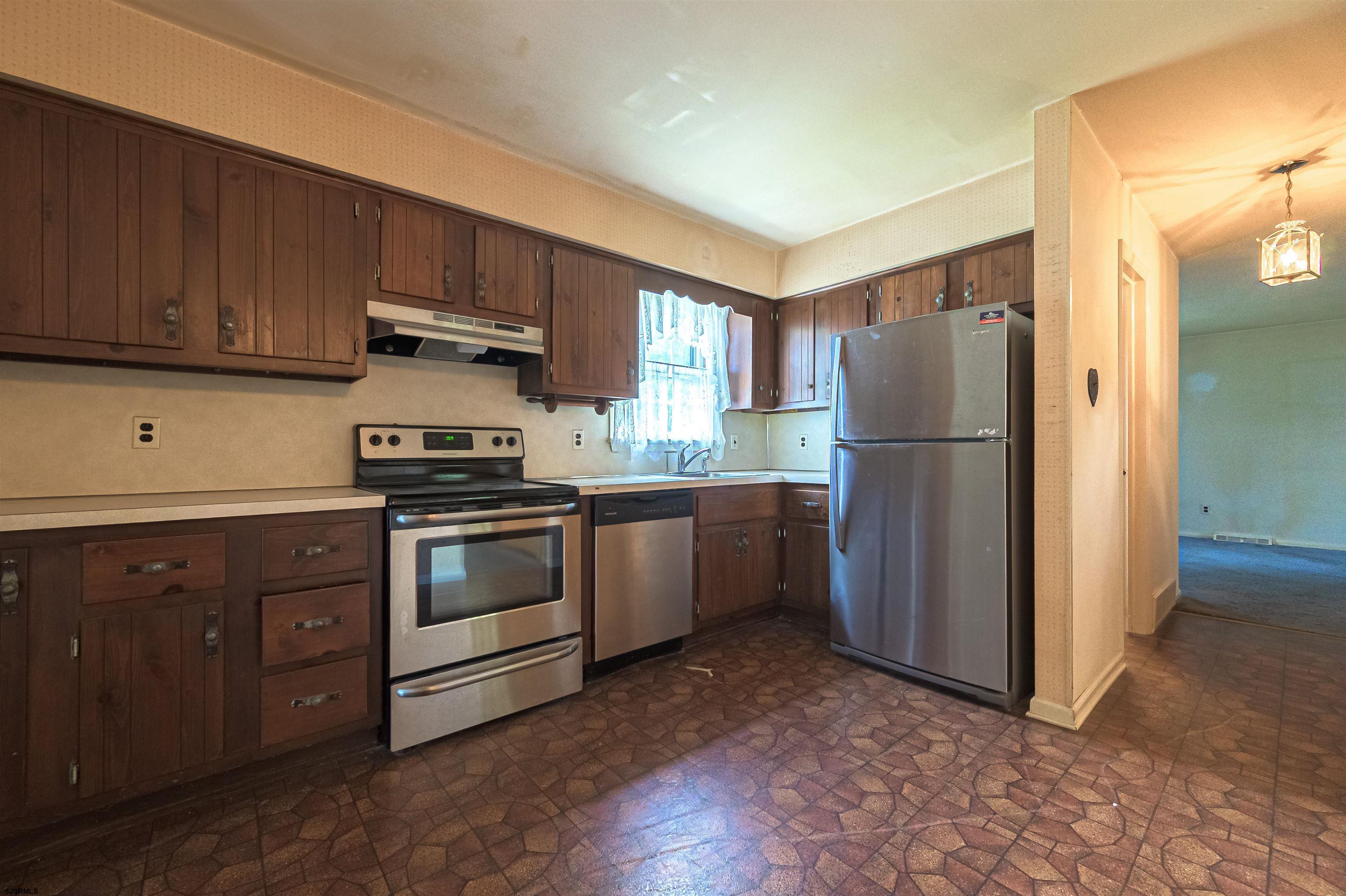 125 North Shore Road Marmora, NJ 08223 - Photo 13 of 29 a kitchen with a refrigerator sink and cabinets