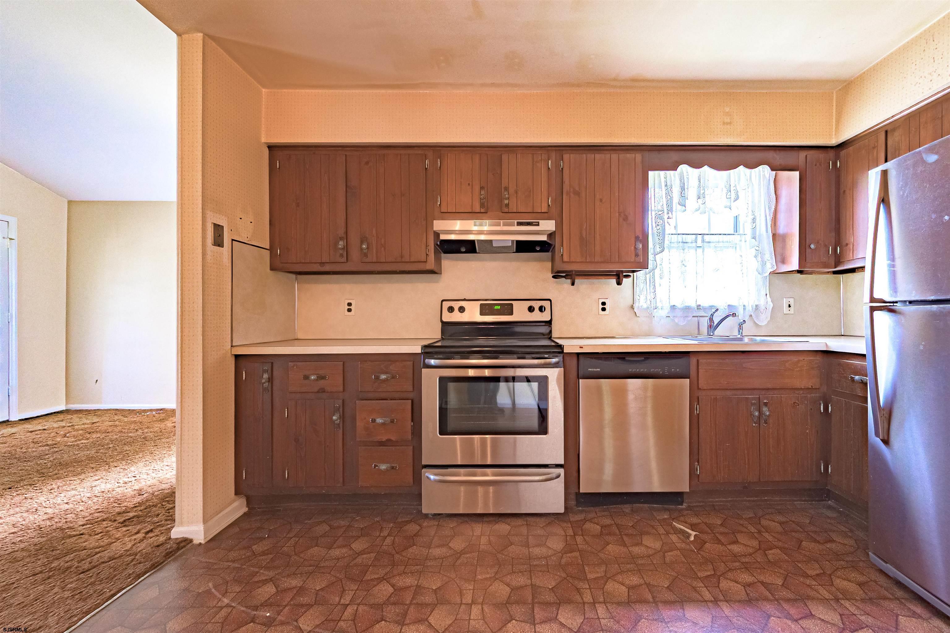125 North Shore Road Marmora, NJ 08223 - Photo 14 of 29 a kitchen with stainless steel appliances a stove a sink and a microwave