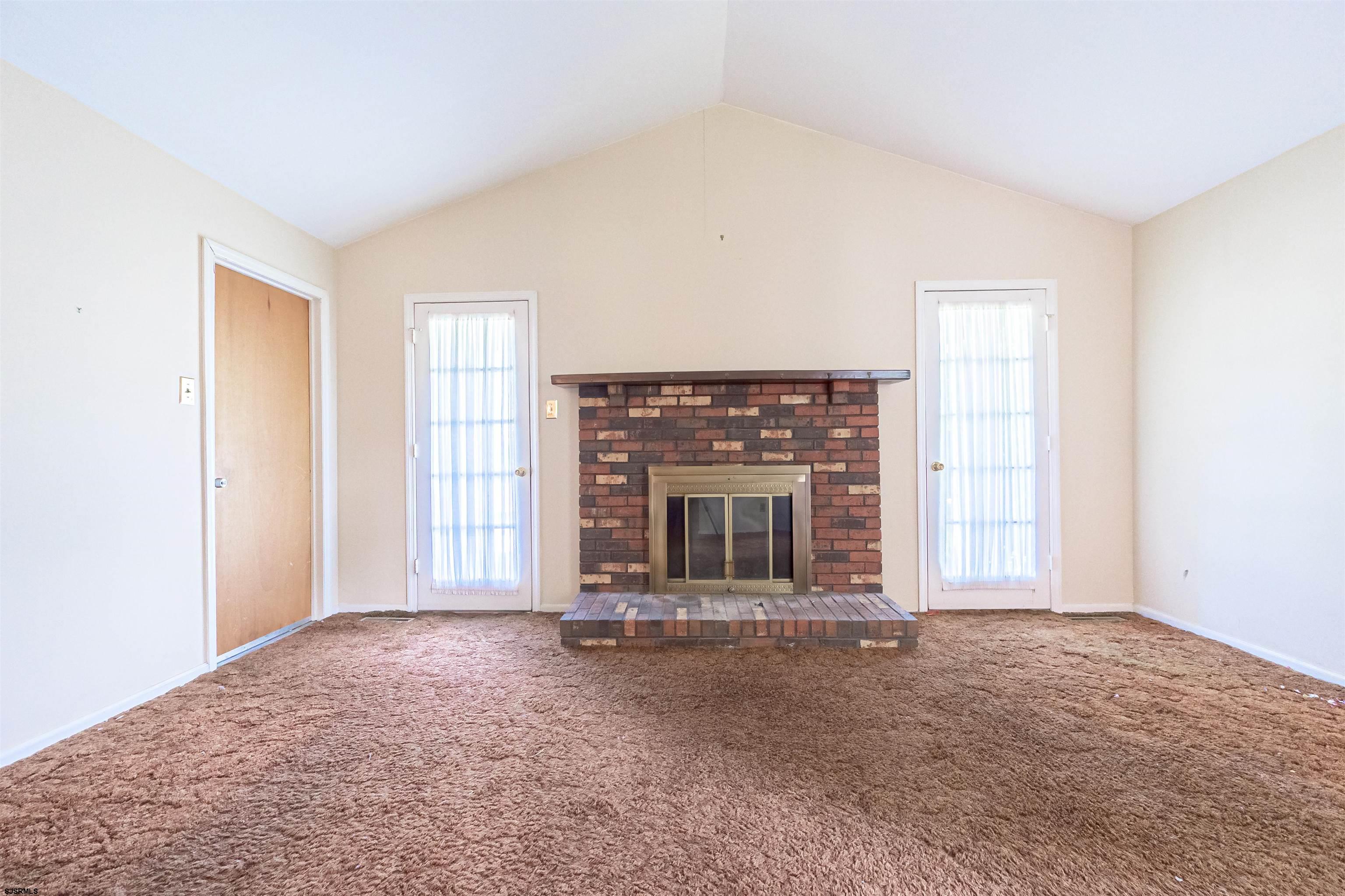 125 North Shore Road Marmora, NJ 08223 - Photo 15 of 29 an empty room with a fireplace and large window