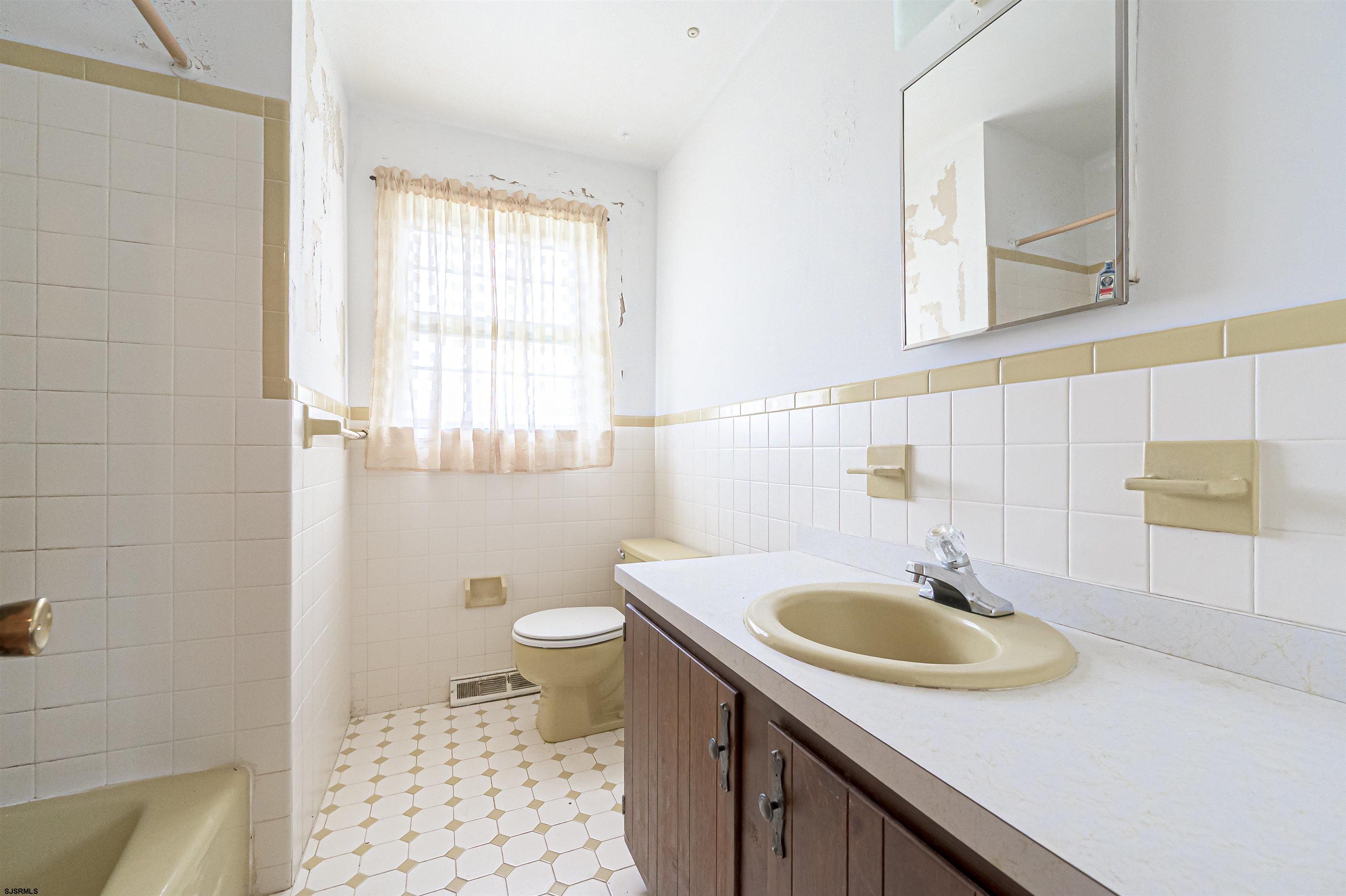 125 North Shore Road Marmora, NJ 08223 - Photo 22 of 29 a bathroom with a sink a toilet and a mirror