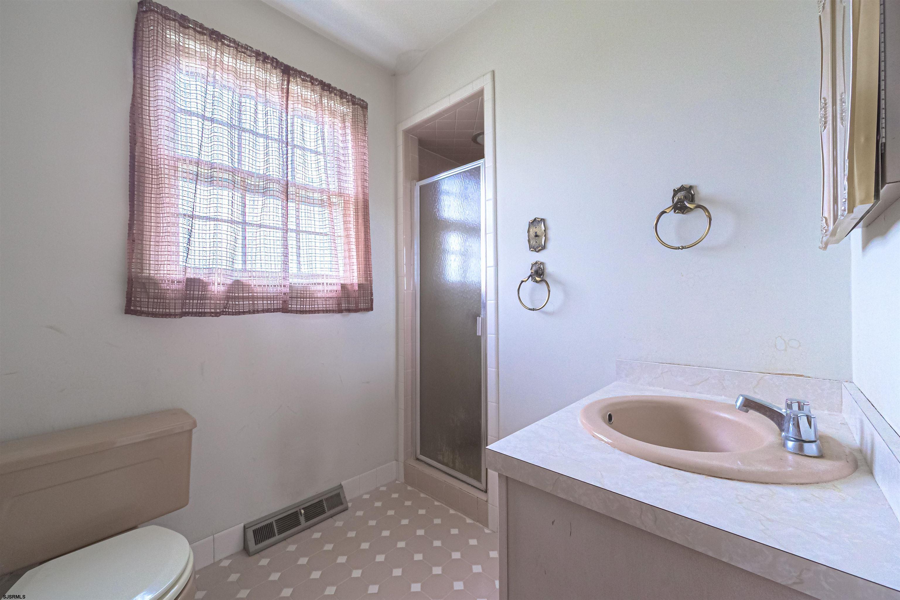 125 North Shore Road Marmora, NJ 08223 - Photo 25 of 29 a bathroom with a sink toilet and window