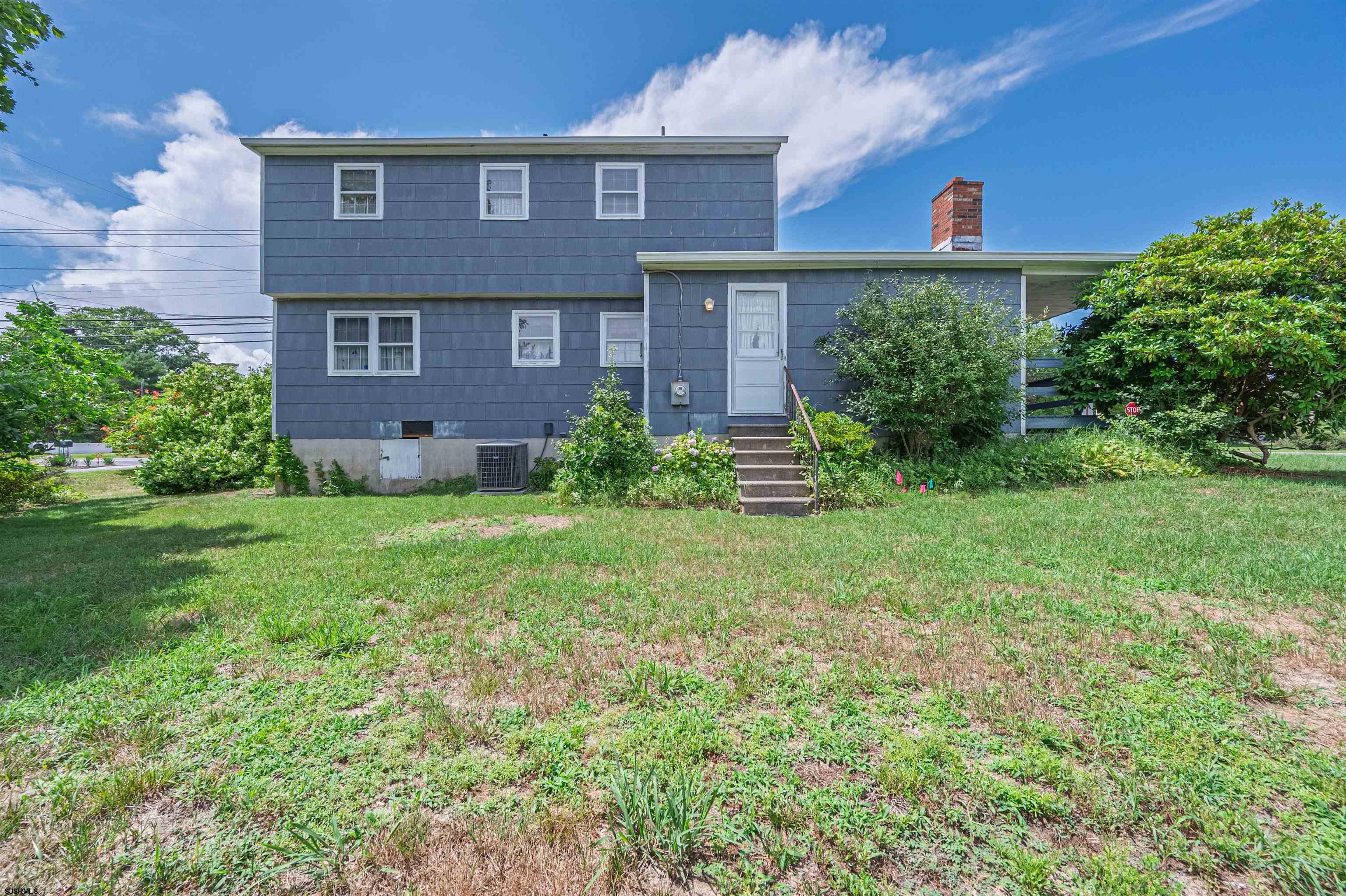 125 North Shore Road Marmora, NJ 08223 - Photo 27 of 29 a view of a brick house with a yard and plants