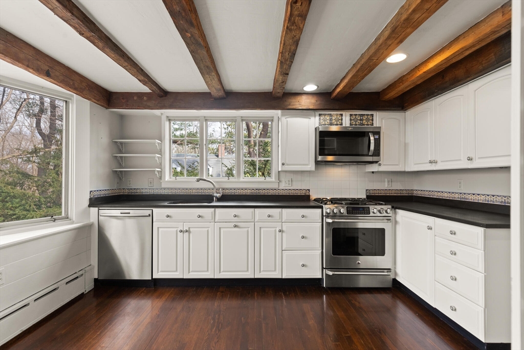 11 Eliot Road Lexington, MA 02421 - Photo 14 of 36 a kitchen with granite countertop white cabinets and a wooden floor
