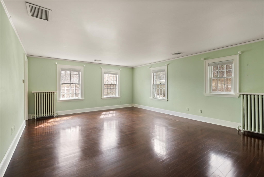 11 Eliot Road Lexington, MA 02421 - Photo 21 of 36 a view of an empty room with wooden floor and a window