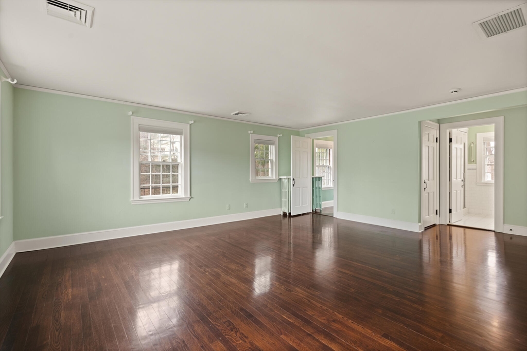 11 Eliot Road Lexington, MA 02421 - Photo 22 of 36 an empty room with wooden floor and windows