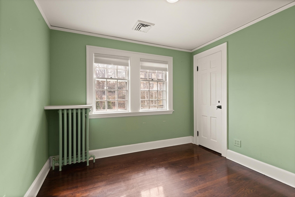 11 Eliot Road Lexington, MA 02421 - Photo 24 of 36 an empty room with wooden floor and windows