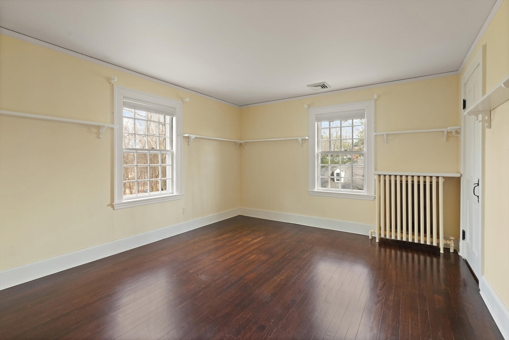 11 Eliot Road Lexington, MA 02421 - Photo 27 of 36 an empty room with wooden floor and windows