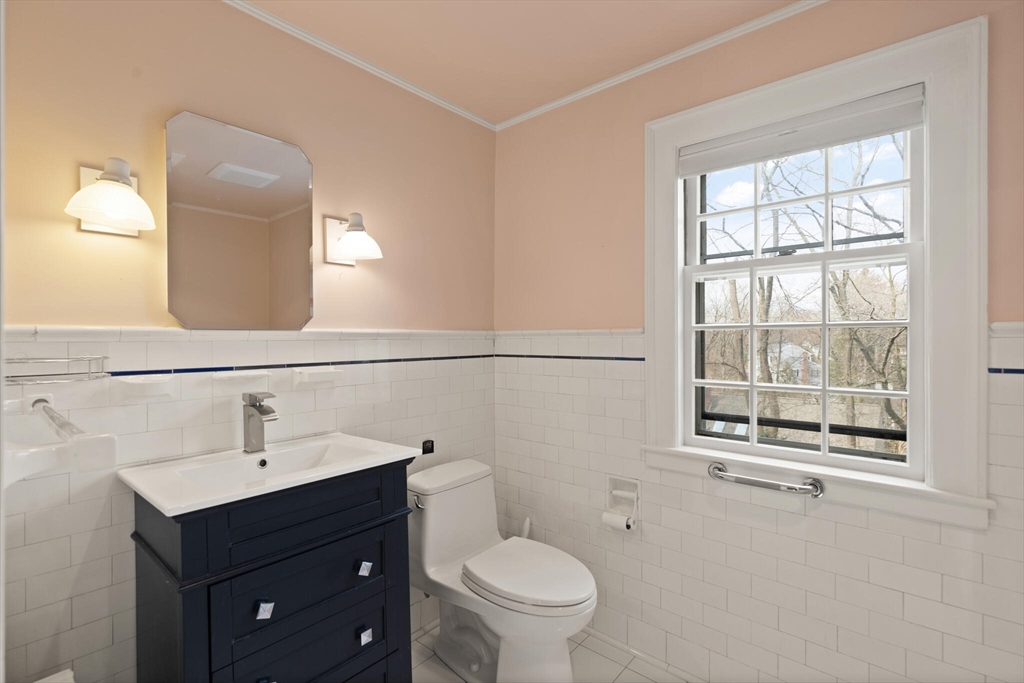 11 Eliot Road Lexington, MA 02421 - Photo 28 of 36 a bathroom with a toilet a sink a window and mirror
