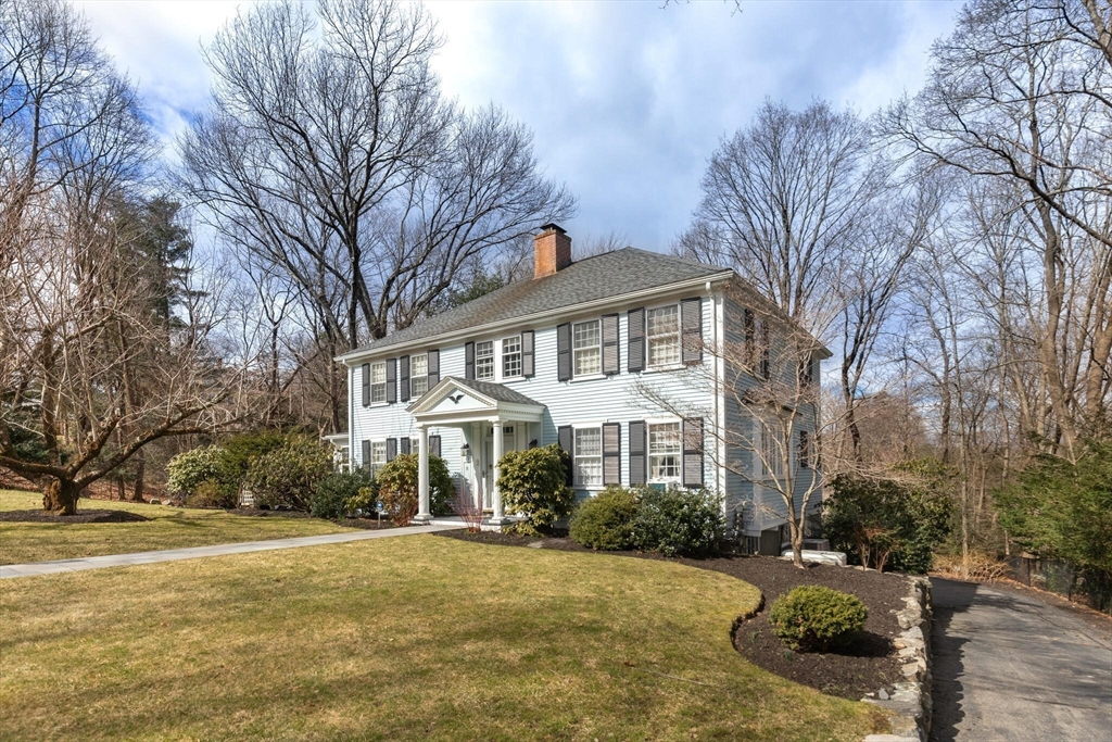11 Eliot Road Lexington, MA 02421 - Photo 30 of 36 a front view of a house with a yard and garage