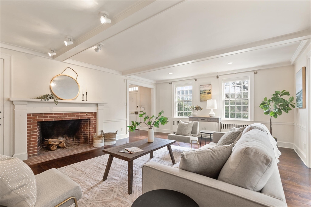 11 Eliot Road Lexington, MA 02421 - Photo 5 of 36 a living room with furniture a fireplace and a large window