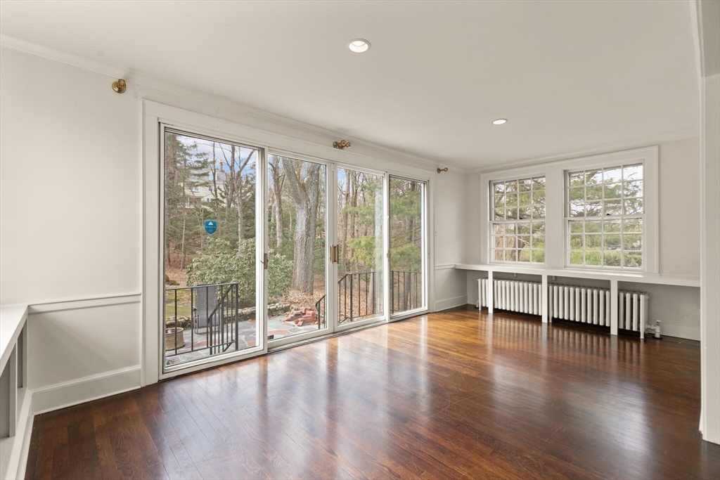 11 Eliot Road Lexington, MA 02421 - Photo 10 of 36 an empty room with wooden floor and windows
