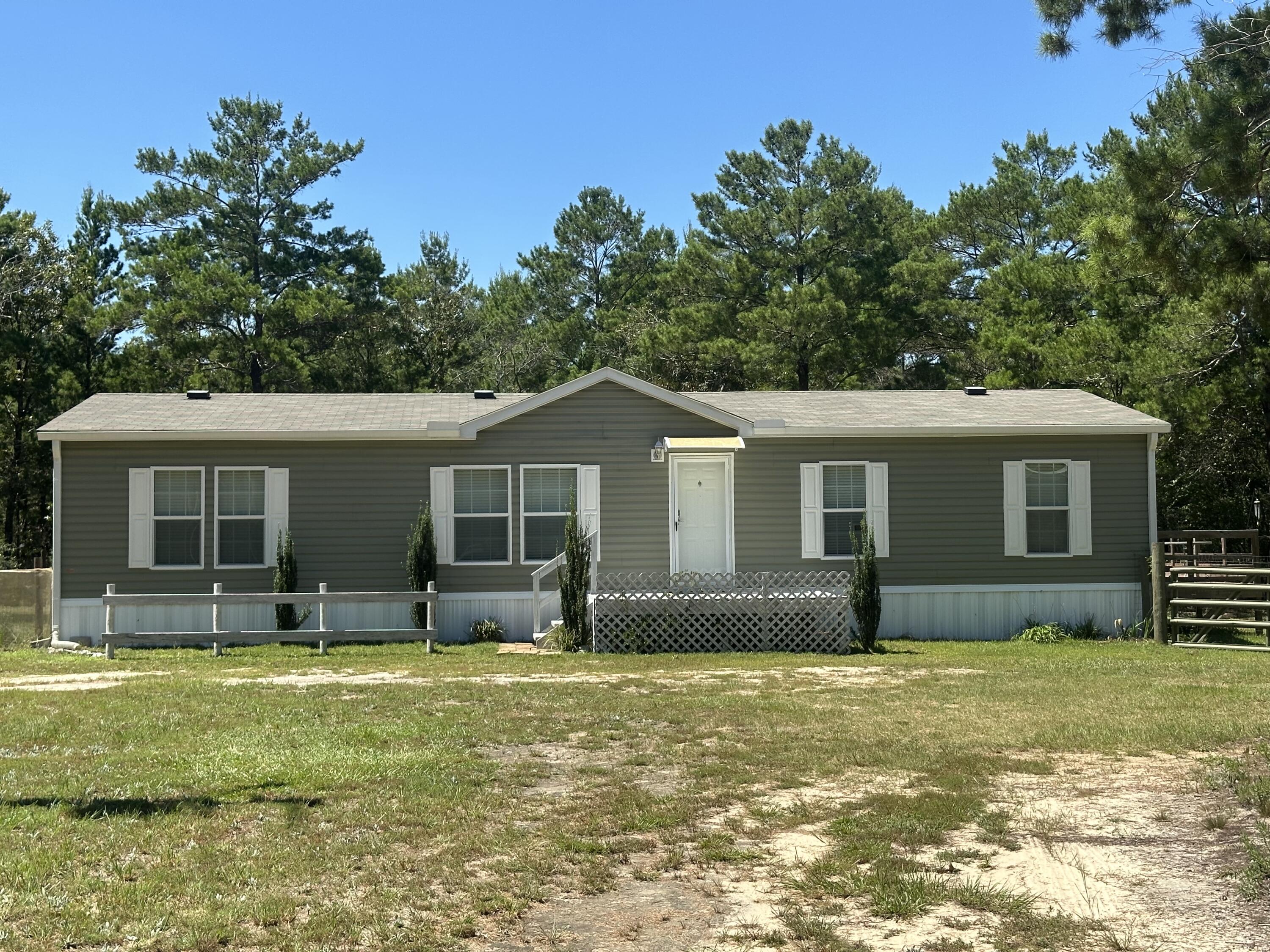 203 Delaware Road DeFuniak Springs, FL 32433 - Photo 3 of 85 a front view of a house with a yard