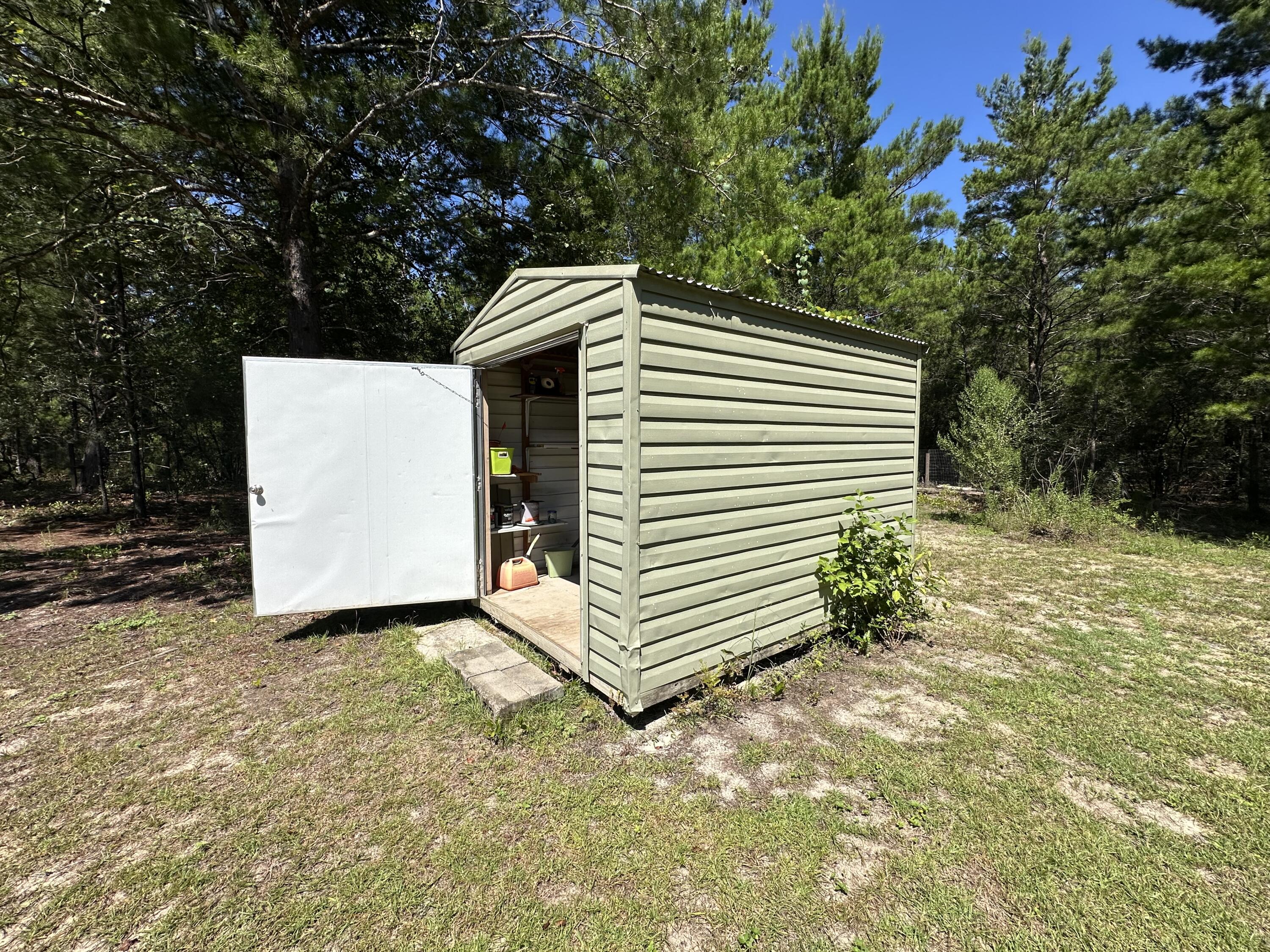 203 Delaware Road DeFuniak Springs, FL 32433 - Photo 47 of 85 a view of a house with a yard and garage