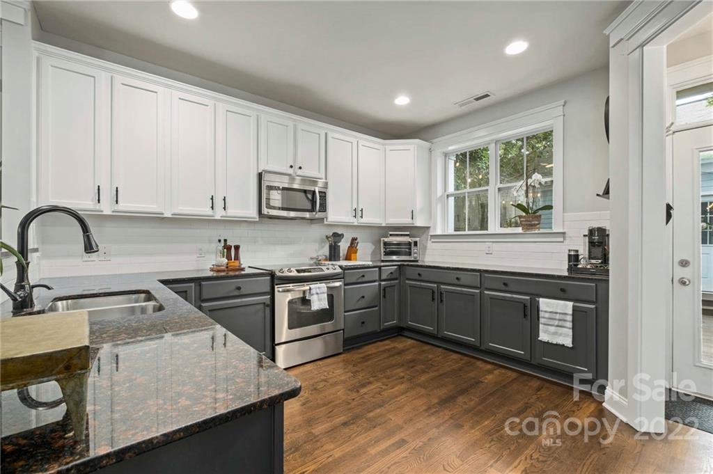 489 Jetton Street Davidson, NC 28036 - Photo 14 of 33 a kitchen with stainless steel appliances granite countertop a stove a sink and a microwave