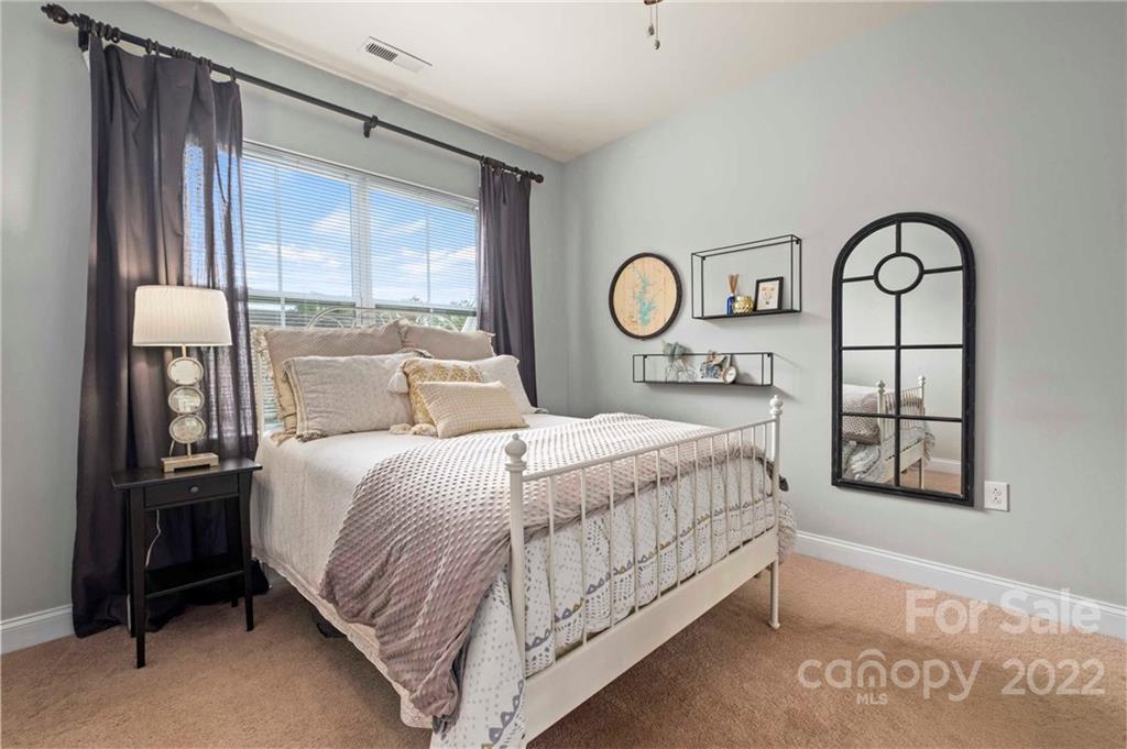 489 Jetton Street Davidson, NC 28036 - Photo 20 of 33 a bedroom with a bed and a window