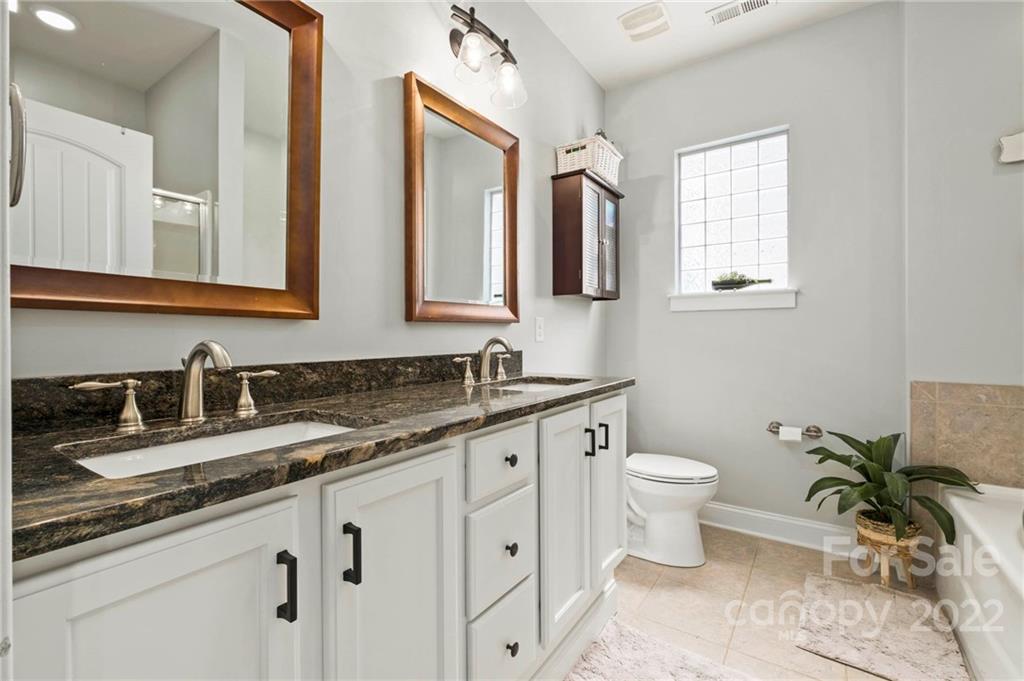 489 Jetton Street Davidson, NC 28036 - Photo 25 of 33 a bathroom with a granite countertop sink mirror and toilet