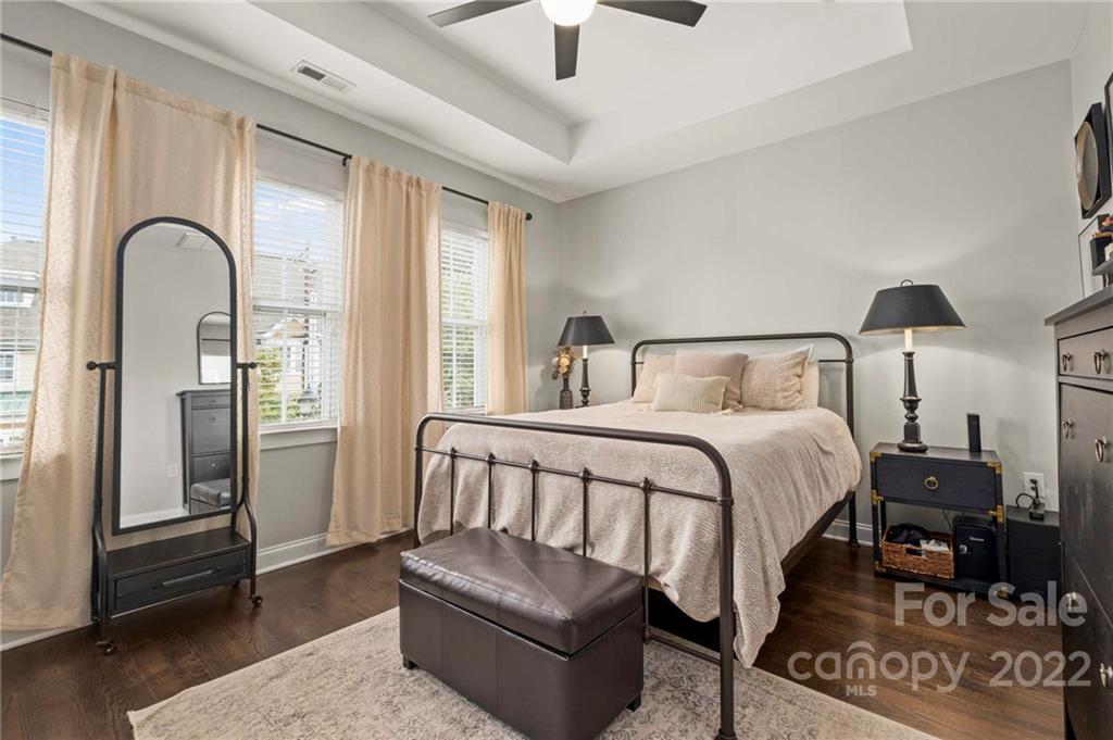 489 Jetton Street Davidson, NC 28036 - Photo 27 of 33 a bedroom with a bed couch and a window