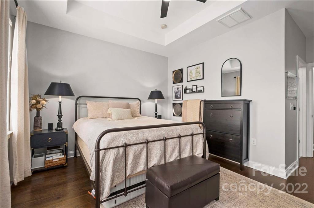 489 Jetton Street Davidson, NC 28036 - Photo 28 of 33 a bedroom with a bed and wooden floor