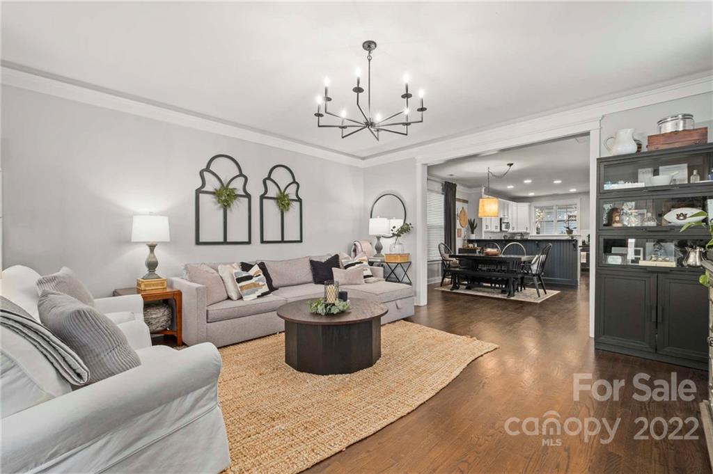 489 Jetton Street Davidson, NC 28036 - Photo 6 of 33 a living room with furniture a chandelier and a rug