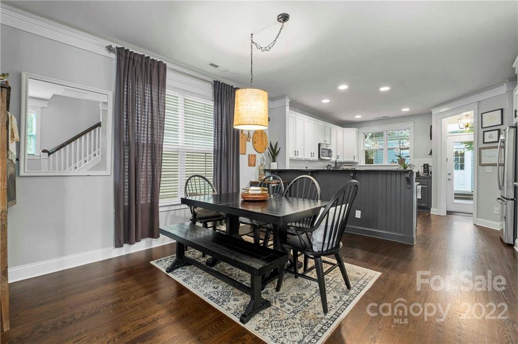 489 Jetton Street Davidson, NC 28036 - Photo 10 of 33 a view of a dining room with furniture window and wooden floor