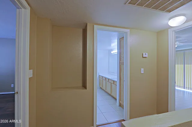 a view of a hallway with wooden floor